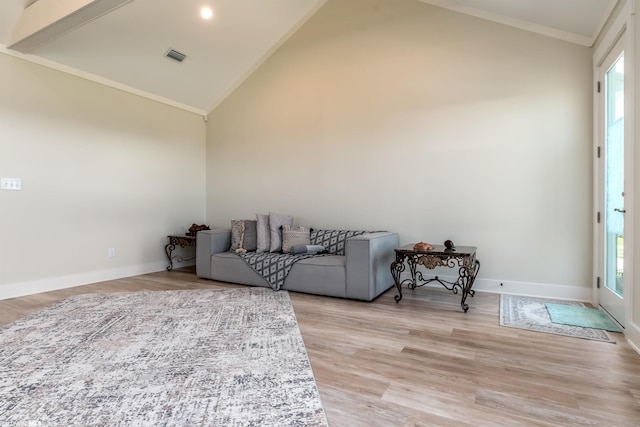 sitting room with high vaulted ceiling, crown molding, and light hardwood / wood-style floors