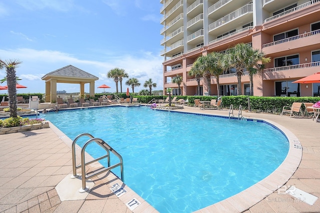 community pool featuring a gazebo and a patio area