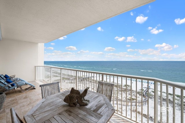 balcony featuring view of water and beach