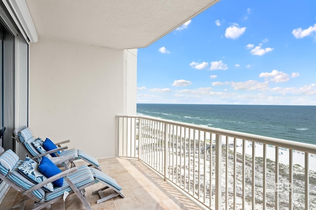 balcony with view of water and beach