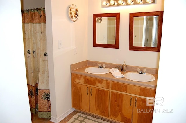 bathroom featuring walk in shower and vanity