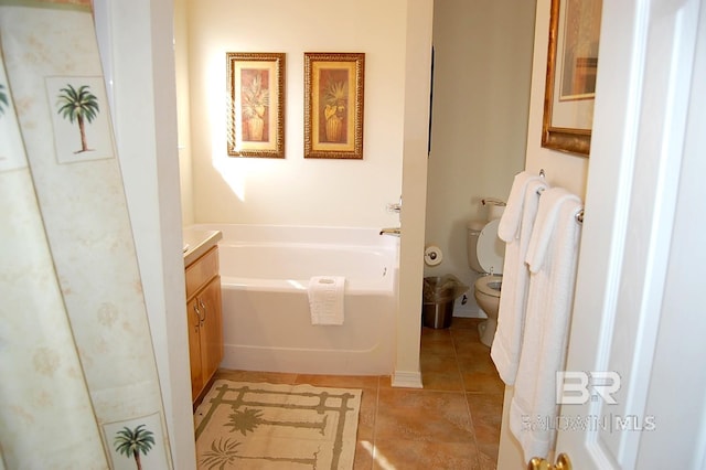 bathroom with tile patterned floors, vanity, toilet, and a tub