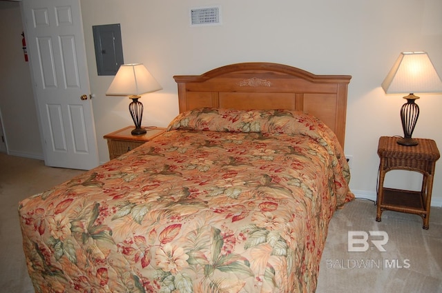 bedroom featuring light colored carpet and electric panel