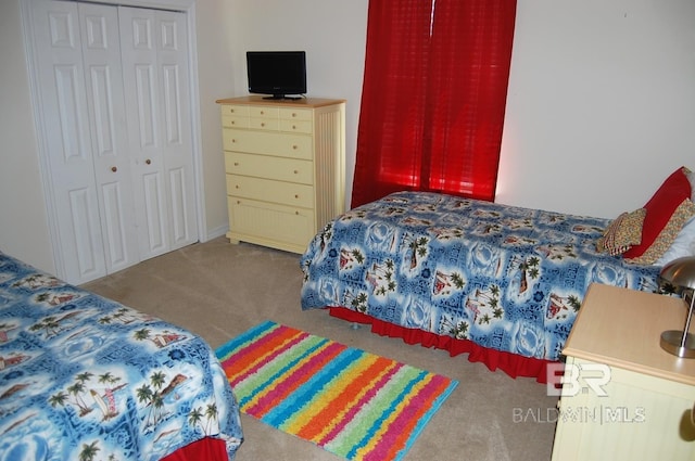 carpeted bedroom with a closet