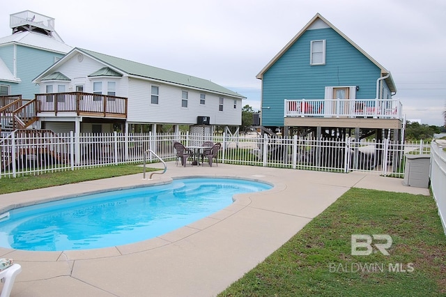 view of swimming pool with a patio and a deck