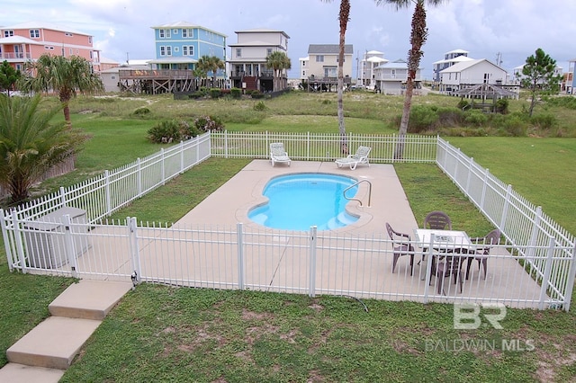 view of pool featuring a yard and a patio area