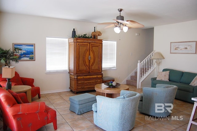 living room featuring light tile patterned floors and ceiling fan