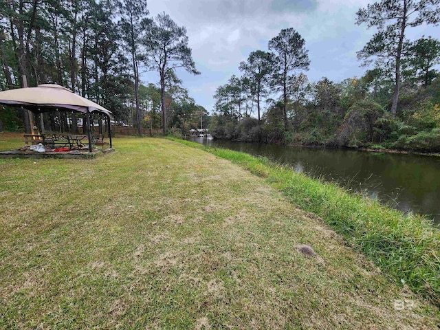 view of yard featuring a gazebo and a water view