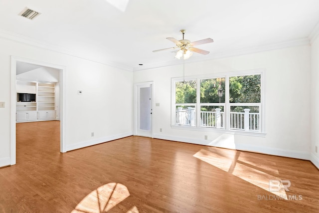 spare room with ceiling fan, light hardwood / wood-style floors, and ornamental molding