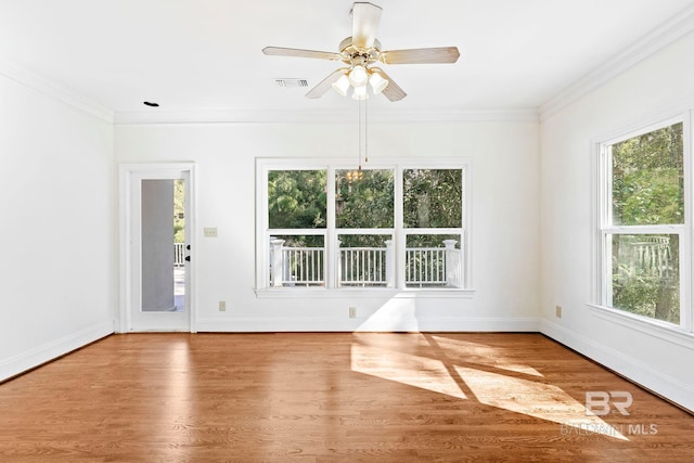 empty room with ceiling fan, wood-type flooring, and ornamental molding