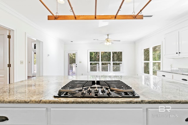 kitchen featuring light stone countertops, ceiling fan, black gas cooktop, crown molding, and white cabinets