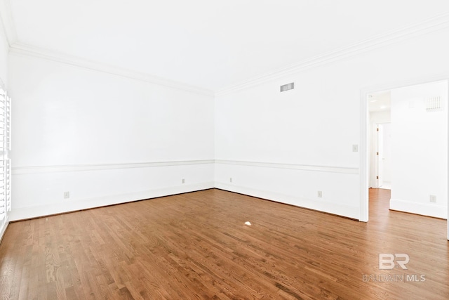 unfurnished room with wood-type flooring and crown molding