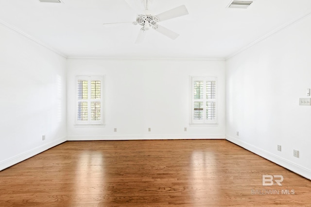 unfurnished room featuring hardwood / wood-style flooring, ceiling fan, and crown molding