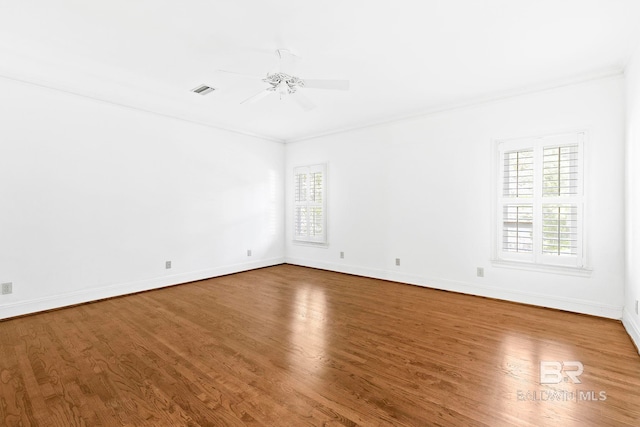 unfurnished room with hardwood / wood-style floors, ceiling fan, and ornamental molding