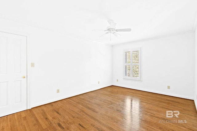 spare room featuring wood-type flooring, ceiling fan, and crown molding