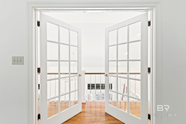 doorway to outside with light hardwood / wood-style flooring and french doors