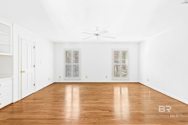 empty room with ceiling fan, light hardwood / wood-style floors, and ornamental molding