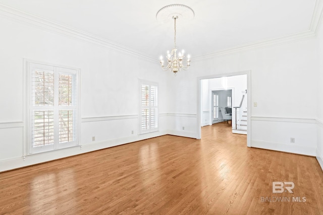 interior space with crown molding, wood-type flooring, and a notable chandelier