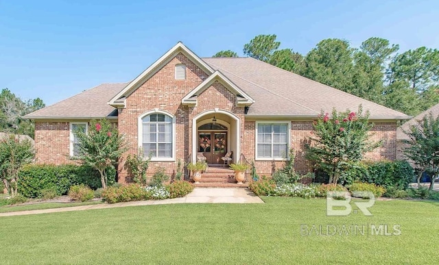 30208 Dolive Rdg, Daphne, AL 36527 - view of front of home featuring brick siding, a front lawn, french doors, and roof with shingles