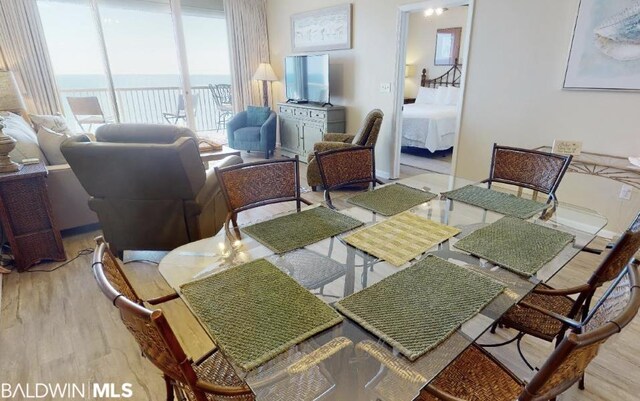 dining room featuring a water view and light hardwood / wood-style flooring