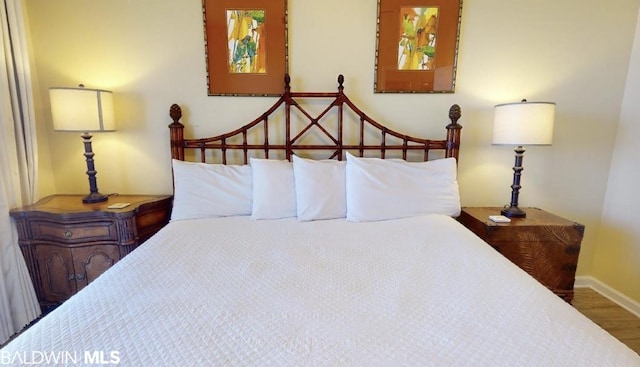 bedroom with dark wood-type flooring