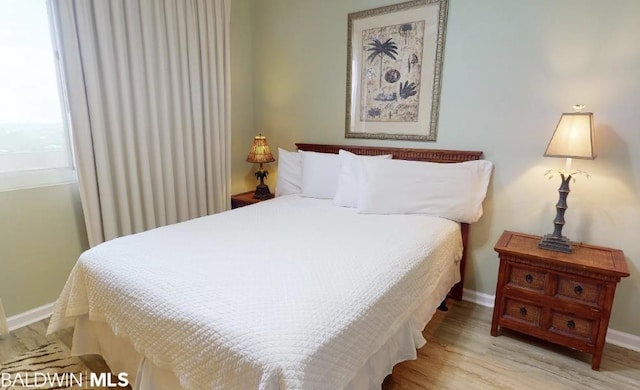 bedroom with light wood-type flooring