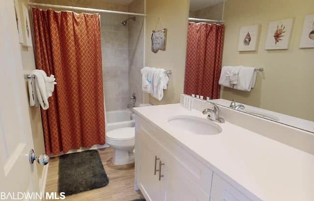 full bathroom featuring shower / bath combination with curtain, toilet, large vanity, and hardwood / wood-style flooring