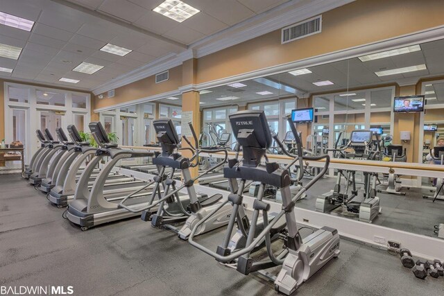 exercise room featuring crown molding and a drop ceiling