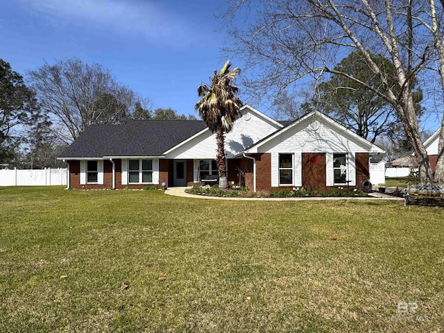 ranch-style house featuring brick siding, fence, and a front yard