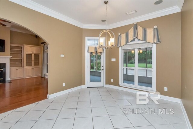 interior space with crown molding, an inviting chandelier, and light hardwood / wood-style floors