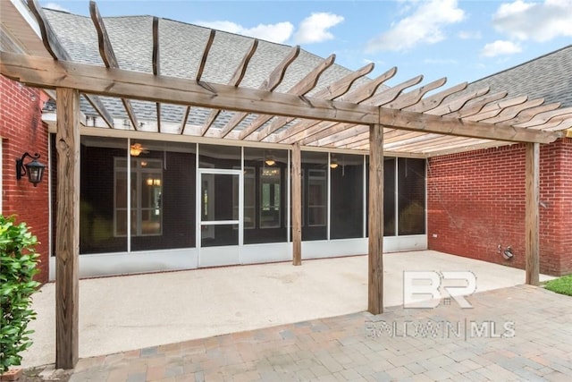 view of patio with a pergola and a sunroom