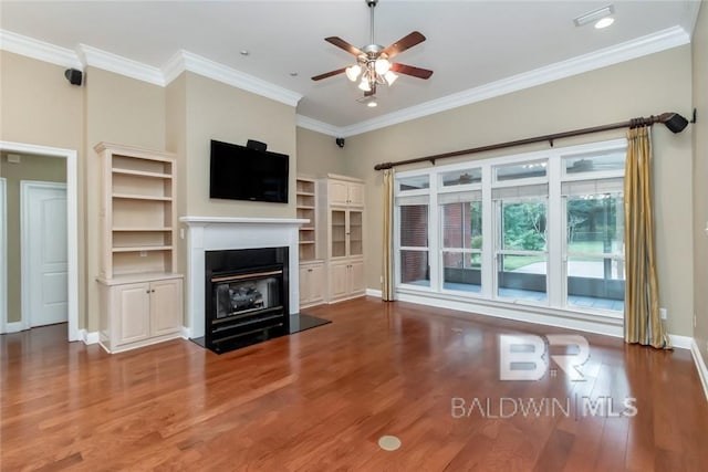 unfurnished living room featuring crown molding, ceiling fan, and dark hardwood / wood-style flooring