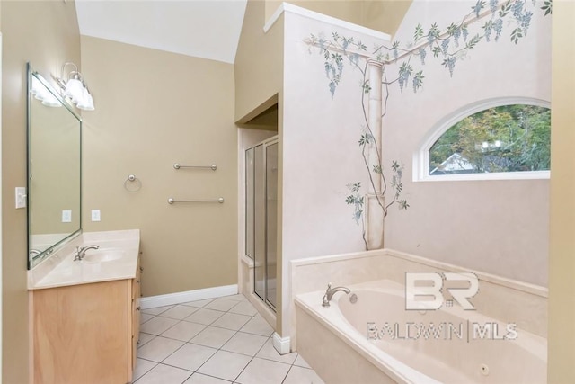 bathroom with plus walk in shower, vaulted ceiling, tile patterned flooring, and vanity