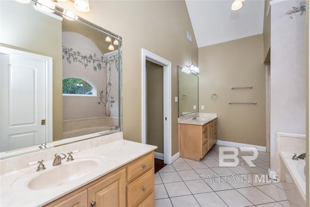 bathroom with a tub to relax in, vanity, tile patterned flooring, and lofted ceiling