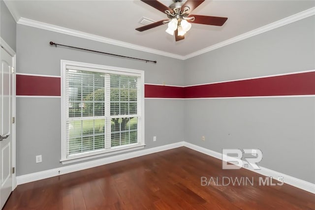 spare room with ornamental molding, dark wood-type flooring, and ceiling fan