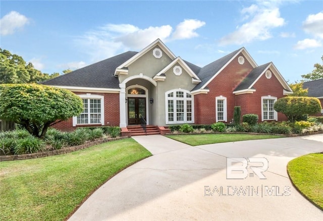 view of front of home with a front lawn and french doors