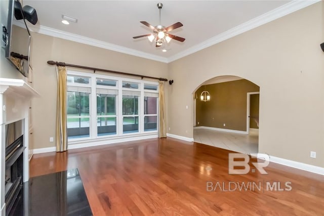 unfurnished living room with crown molding, ceiling fan, and wood-type flooring