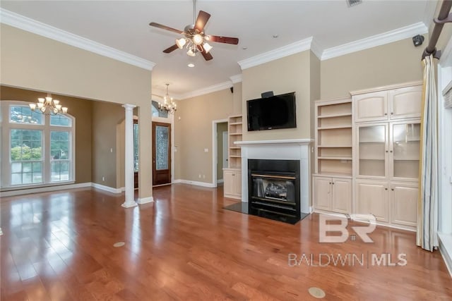 unfurnished living room featuring ornate columns, ceiling fan with notable chandelier, hardwood / wood-style flooring, and ornamental molding