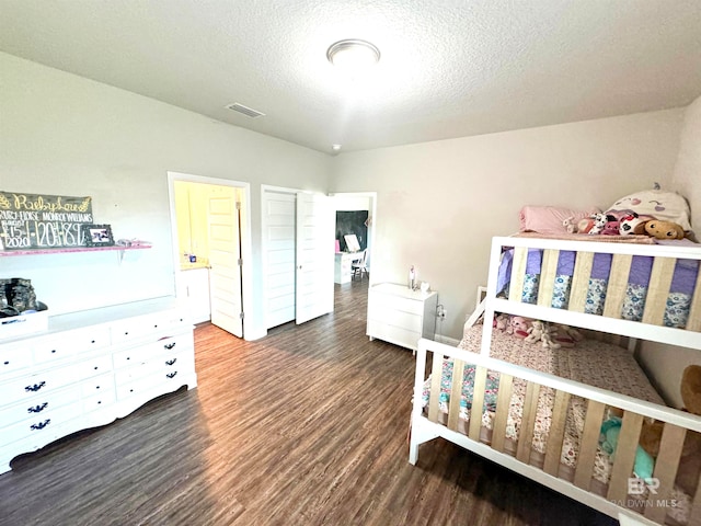 bedroom featuring hardwood / wood-style floors and a textured ceiling