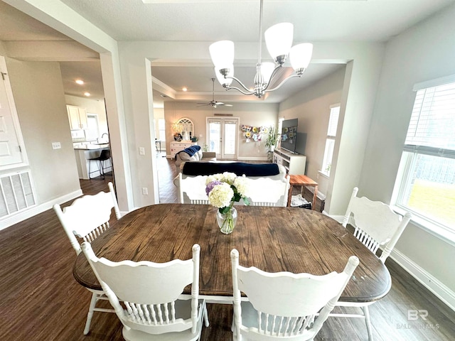 dining space with french doors, dark hardwood / wood-style flooring, and ceiling fan with notable chandelier