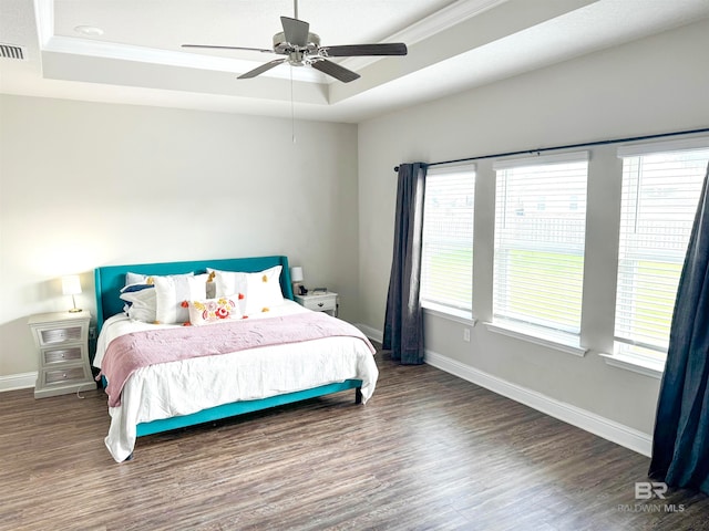 bedroom with dark hardwood / wood-style flooring, multiple windows, and ceiling fan