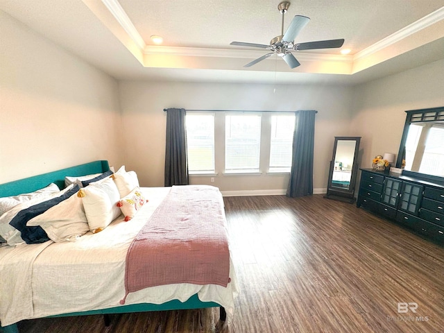 bedroom featuring ornamental molding, a raised ceiling, ceiling fan, and dark hardwood / wood-style flooring