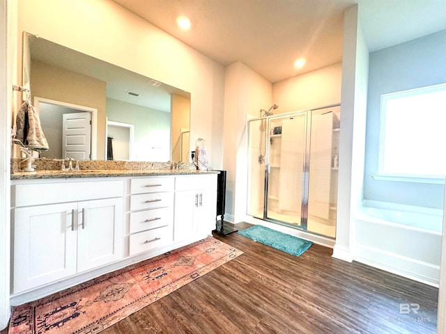 bathroom featuring vanity, hardwood / wood-style floors, and separate shower and tub