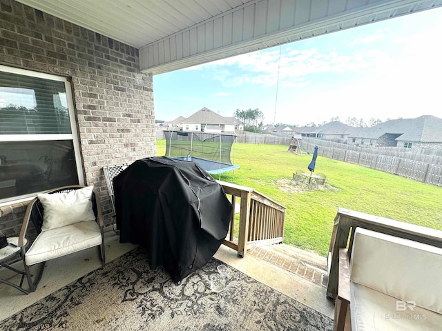 view of patio with a trampoline and grilling area