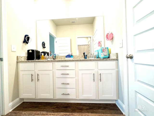 bathroom with vanity and hardwood / wood-style flooring