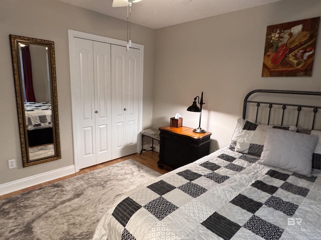 1052 Orlando Dr, Foley, AL 36535 - bedroom with a closet, wood finished floors, ceiling fan, and baseboards