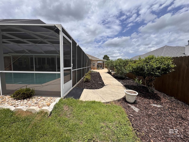 1052 Orlando Dr, Foley, AL 36535 - view of yard with glass enclosure and a patio area