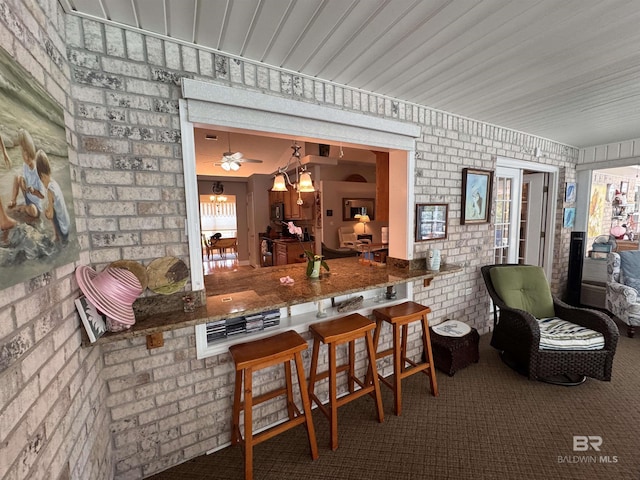 1052 Orlando Dr, Foley, AL 36535 - bar area featuring brick wall and carpet flooring
