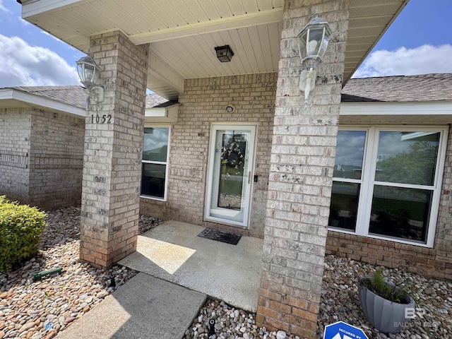 1052 Orlando Dr, Foley, AL 36535 - view of exterior entry with roof with shingles and brick siding