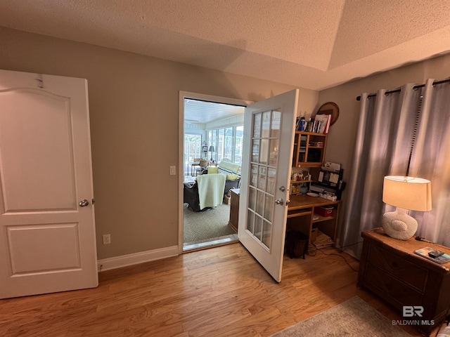 1052 Orlando Dr, Foley, AL 36535 - doorway to outside featuring light wood finished floors, a textured ceiling, a desk, baseboards, and french doors